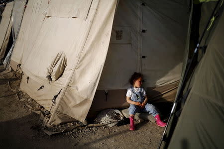 A child sleeps near a tent at a makeshift camp for refugees and migrants at the Greek-Macedonian border near the village of Idomeni, Greece. REUTERS/Stoyan Nenov