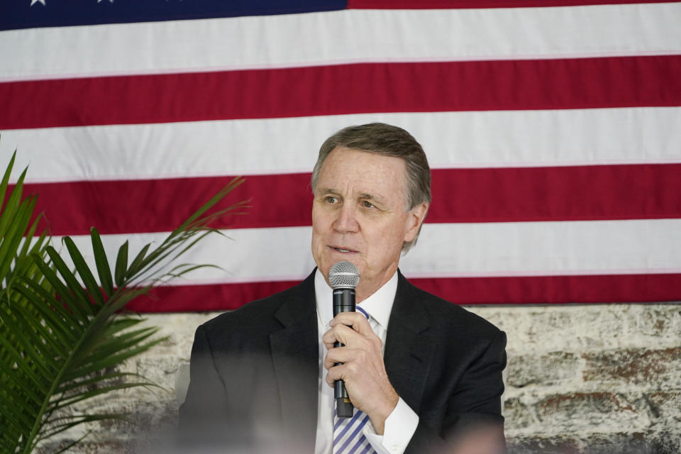 Sen. David Perdue speaks into a microphone