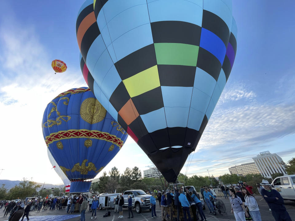 Hot air balloons prepare to lift off as part of a re-enactment of the first Albuquerque International Balloon Fiesta in 1972 during a special event at Coronado Center in Albuquerque, New Mexico, on Friday, Sept. 30, 2022. Hundreds of balloons will ascend during the nine-day annual fiesta that has drawn pilots and spectators from across the globe for 50 years. (AP Photo/Susan Montoya Bryan)