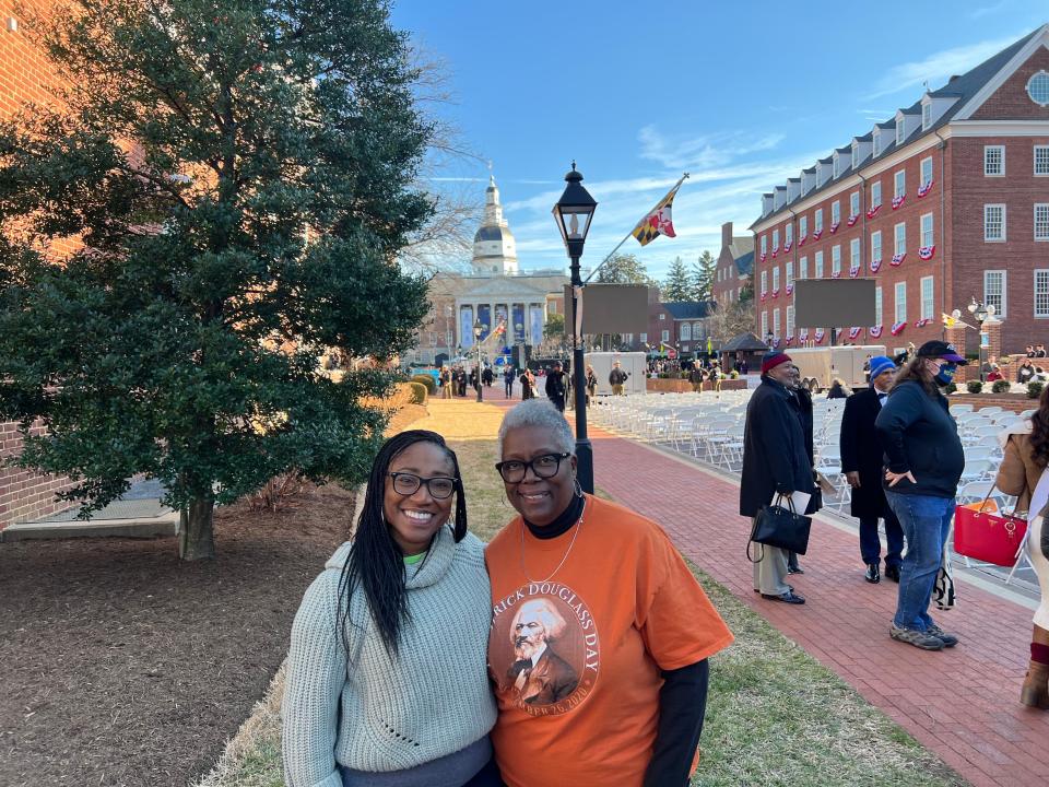 Dana Bowser, left, and Harriette Lowery, right, stand with the State House in the background after the inauguration of Wes Moore. Both women came from Talbot County on a bus paid for by the Moore transition team.