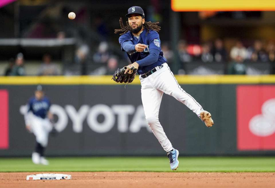 Seattle Mariners shortstop J.P. Crawford throws to first base for an out against Oakland Athletics' Ryan Noda during the fourth inning of a baseball game Monday, May 22, 2023, in Seattle. (AP Photo/Lindsey Wasson)