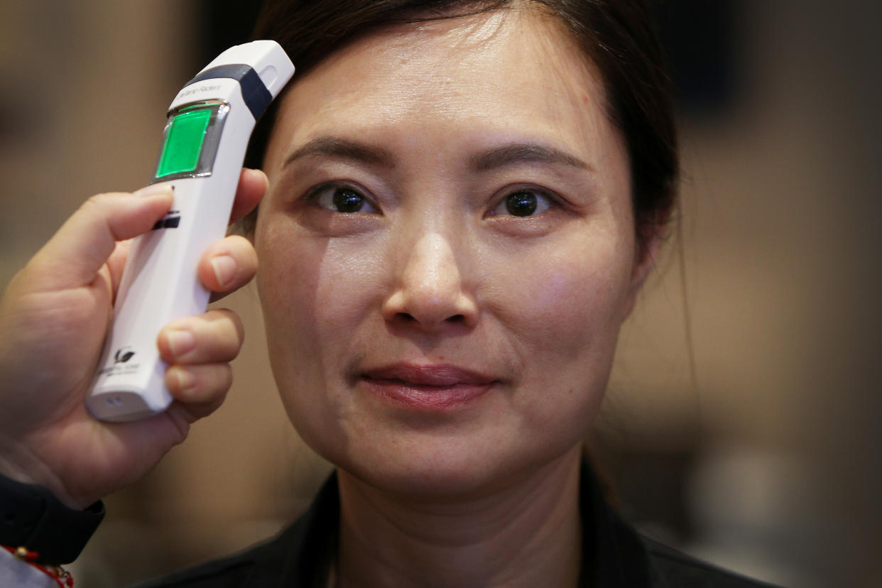 SYDNEY, AUSTRALIA - MARCH 05: Customer service worker Candy Huang has her temperature checked at the award winning Golden Century Seafood Restaurant in Chinatown on March 05, 2020 in Sydney, Australia. The Golden Century Seafood Restaurant has experienced a sudden drop in clientele of 50% this past week. To help safeguard against the coronavirus outbreak they have implemented daily temperature screening of all employees, hourly cleaning of all main public surfaces, including all handrails and the provision of customer hand sanitiser. Chinese restaurant owners across Sydney say the current restrictions in place on people travelling from mainland China to Australia means they have lost the majority of their usual clientele - Chinese tourists and students. A number of restaurants have already gone into liquidation. (Photo by Lisa Maree Williams/Getty Images)