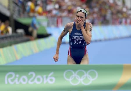 Gold medalist Gwen Jorgensen of the U.S. reacts as she crosses finish line in the triathlon. REUTERS/Carlos Barria