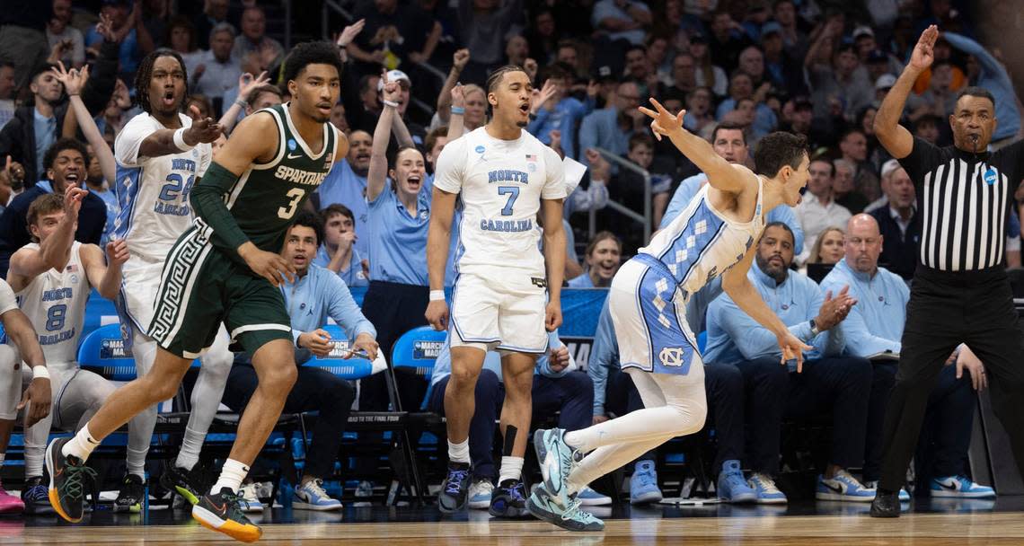 North Carolina’s Cormac Ryan (3) and the Tar Heels’ bench react after Cormac’s three point basket to stretch the Tar Heels’ lead to 12 points in the second half against Michigan State’s during the first half on Saturday, March 23, 2024, during the second round of the NCAA Tournament at Spectrum Center in Charlotte, N.C. Ryan scored 14 point sin their 85-69 victory.