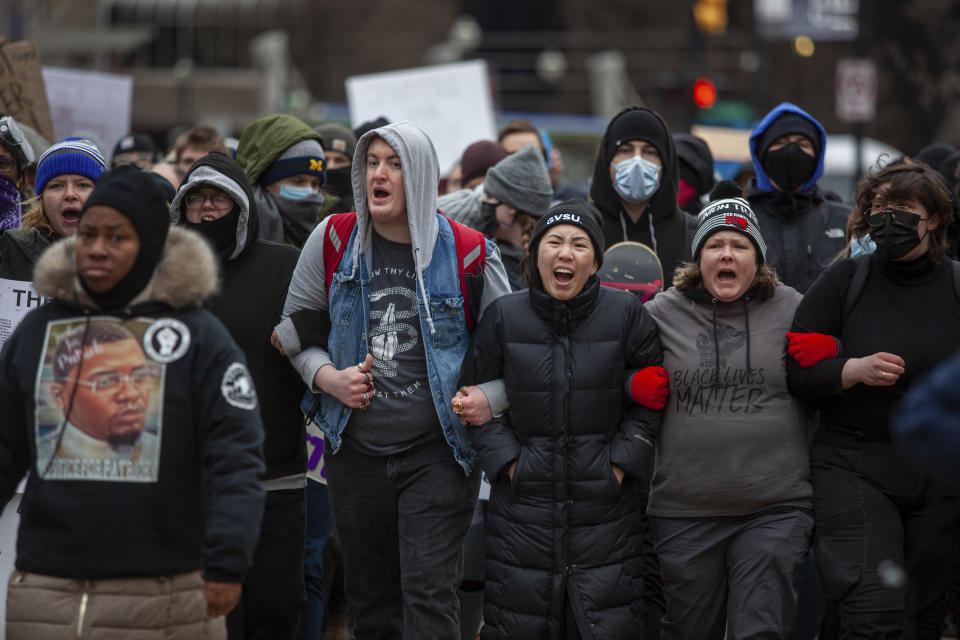 Protesters chant and lock arms as they approach police lines during a march through Grand Rapids, Mich., April 16, 2022. Activists have held protests for four straight days since the release of a video showing 26-year-old Congolese immigrant Patrick Lyoya being shot and killed by a Grand Rapids police officer while resisting arrest during a traffic stop on April 4. (Daniel Shular/The Grand Rapids Press via AP)