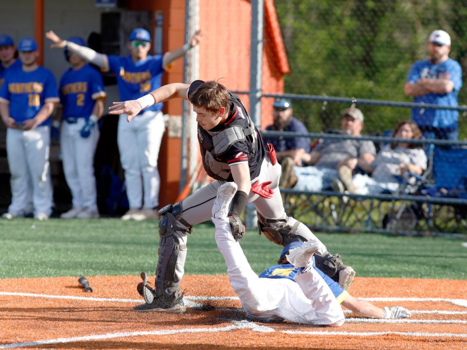 Bentley Cunningham lays the tag on Kolton Gifford at home plate during Coshocton's 6-1 loss to host Maysville on Thursday at the Maysville Athletic Complex.