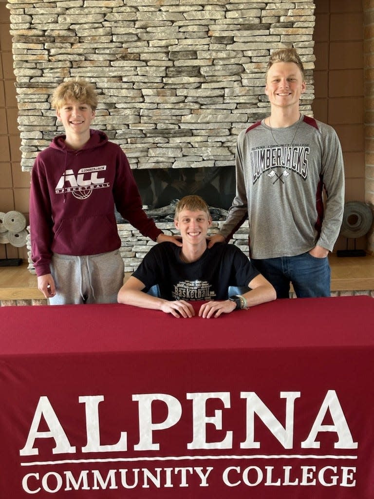 Onaway senior basketball star Jadin Mix (middle) officially signed to play men's basketball at Alpena Community College on Saturday.