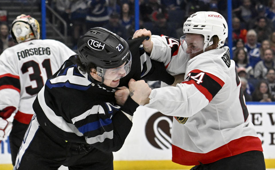 Tampa Bay Lightning center Michael Eyssimont and Ottawa Senators defenseman Jacob Bernard-Docker (24) fight during the second period of an NHL hockey game, Monday, Feb. 19, 2024, in Tampa, Fla. (AP Photo/Jason Behnken)