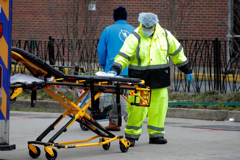 Worker sprays disinfectant on stretcher outside Brooklyn Hospital Center during the coronavirus disease (COVID-19) in New York