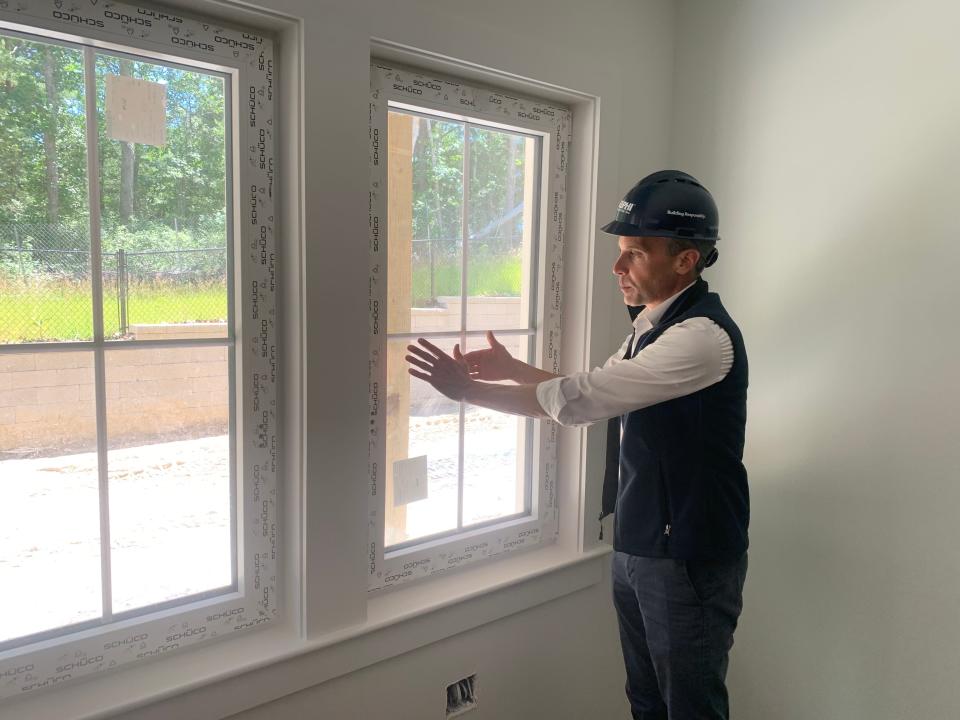 Corey Heaslip, vice president of Delphi Construction Inc., explains the high-performance windows of Brewster Woods.