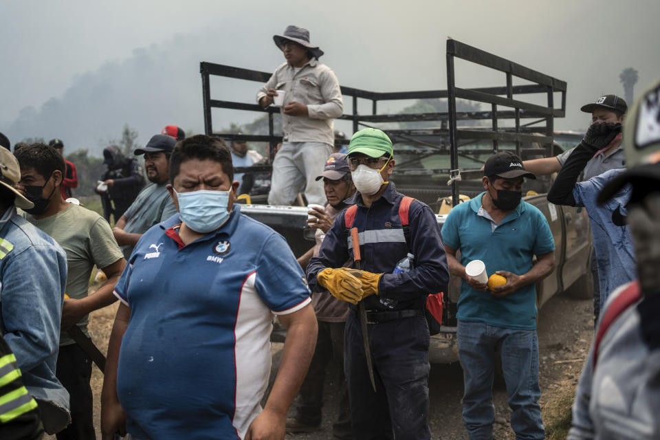 Villagers arrive to take part in efforts to contain a wildfire in Nogales, in the High Mountains area of Veracruz state, Mexico, Monday, March 25, 2024. (AP Photo/Felix Marquez)