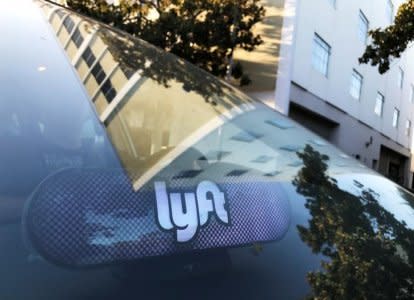 An illuminated sign appears in a Lyft ride-hailing car in Los Angeles, California, U.S. September 21, 2017. REUTERS/Chris Helgren