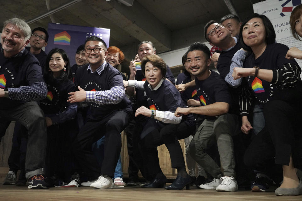 Tokyo 2020 Organizing Committee President Seiko Hashimoto, center, poses for a photo with representatives and staff at Pride House Tokyo Legacy during her visit to the house, in Tokyo Tuesday, April 27, 2021. Japan marked LGBTQ week with pledge to push for equality law before the Olympics. (AP Photo/Eugene Hoshiko, Pool)