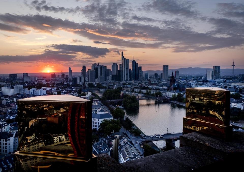 The city's skyline is seen between two golden pinnacles on top of a hotel in Frankfurt, Germany, Tuesday, Sept. 22, 2020. (AP Photo/Michael Probst)