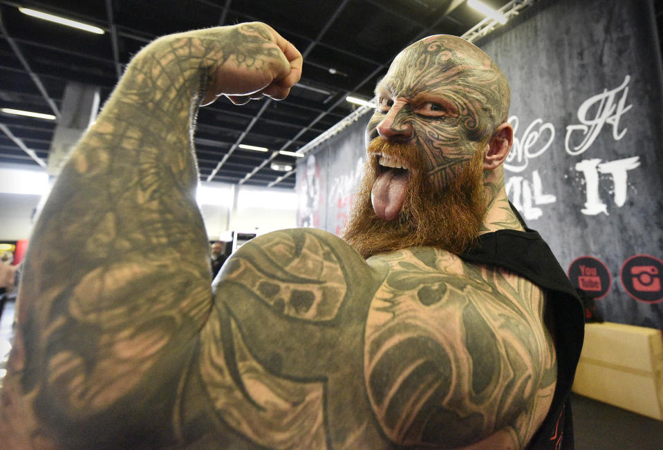 FILE - In this Thursday, April 12, 2018 file photo bodybuilder Jens shows his muscles at the world's largest fitness trade show FIBO in Cologne, Germany. (AP Photo/Martin Meissner, File)