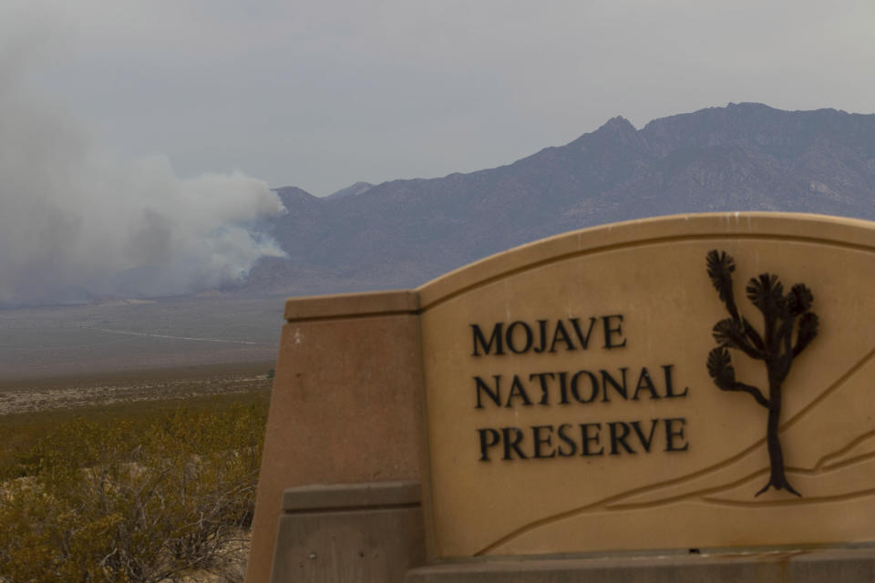 Smoke rises from a mountain range during the York Fire on Sunday, July 30, 2023, in the Mojave National Preserve, Calif. Crews battled “fire whirls” in California’s Mojave National Preserve this weekend as a massive wildfire crossed into Nevada amid dangerously high temperatures and raging winds. (AP Photo/Ty O'Neil)
