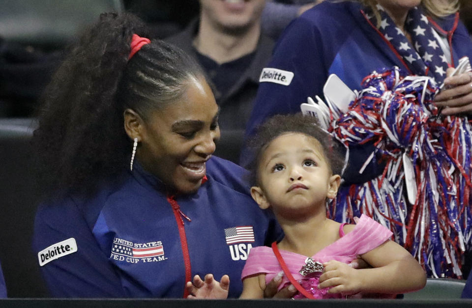 FILE - United States' Serena Williams sits with her daughter, Alexis Olympia Ohanian Jr., as they look on during a Fed Cup qualifying tennis match Saturday, Feb. 8, 2020, in Everett, Wash. After nearly three decades in the public eye, few can match Serena Williams' array of accomplishments, medals and awards. Through it all, the 23-time Grand Slam title winner hasn't let the public forget that she's a Black American woman who embraces her responsibility as a beacon for her people. (AP Photo/Elaine Thompson, File)