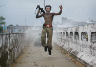 <p>A Liberian militia commander loyal to the government exults after firing a rocket-propelled grenade at rebel forces at a key strategic bridge July 20, 2003 in Monrovia, Liberia. Government forces succeeded in forcing back rebel forces in fierce fighting on the edge of Monrovia’s city center. </p>