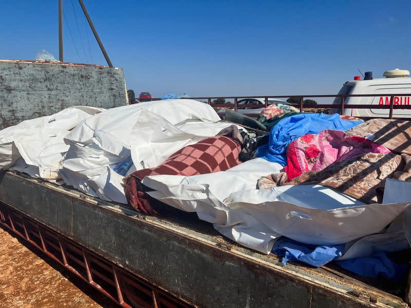 Bodies of victims are placed at a mass grave after a powerful storm and heavy rainfall hit Libya