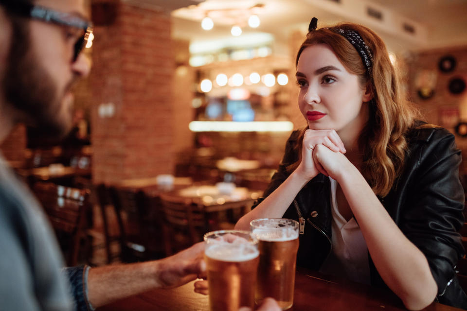 Man and woman looking serious on first date. (Getty Images)