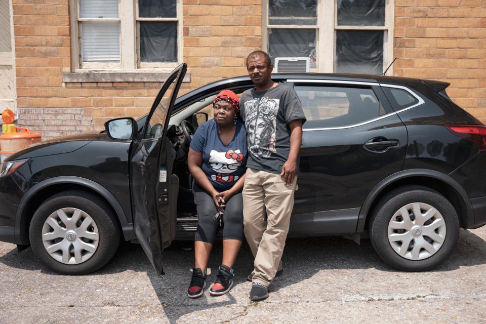 Katherine Harris and Fred Scott stand for a portrait with their Nissan Rogue in May.