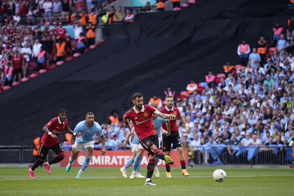 Manchester United's Bruno Fernandes scores on a penalty kick during the English FA Cup final soccer match between Manchester City and Manchester United at Wembley Stadium in London, Saturday, June 3, 2023. (AP Photo/Dave Thompson)