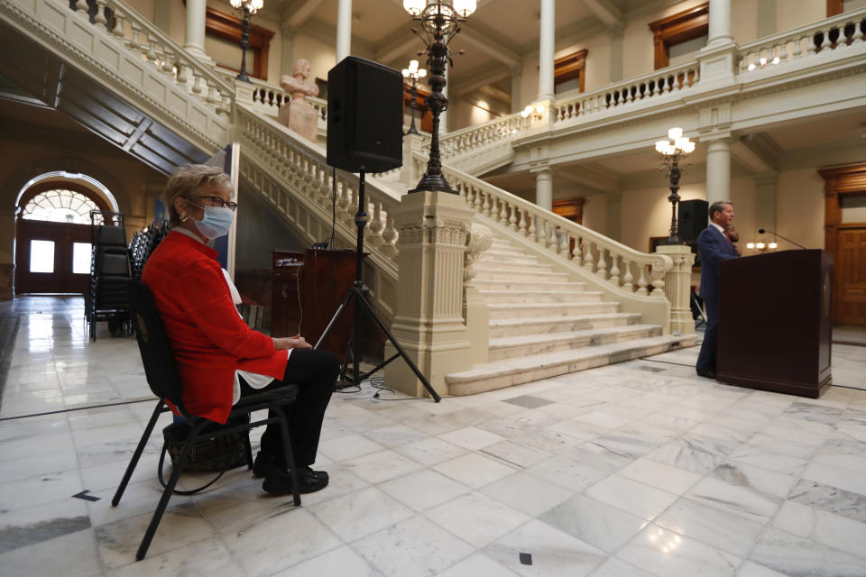 Georgia Department of Public Health commissioner Kathleen Toomey looks on as Gov. Brian Kemp speaks during a coronavirus briefing at the Capitol Friday, July 17, 2020, in Atlanta. (AP Photo/John Bazemore)