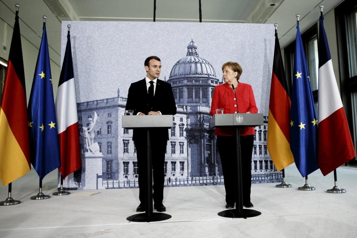 Emmanuel Macron and Angela Merkel at Thursday’s press conference in Berlin: Getty