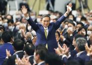 Japanese Chief Cabinet Secretary Suga gestures as he is elected as new head of the ruling party at the Liberal Democratic Party's (LDP) leadership election in Tokyo