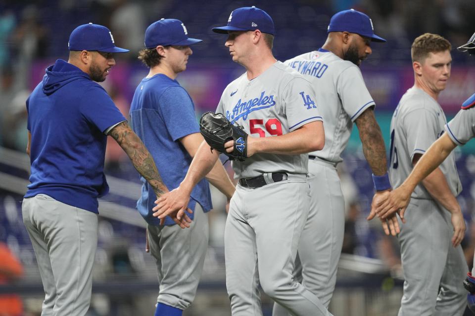 Los Angeles Dodgers relief pitcher Evan Phillips (59) celebrates a victory over the Miami Marlins with teammates at loanDepot Park.
