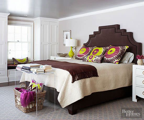 Different shades of gray on the ceiling, trim, and walls create visual interest in this bedroom.