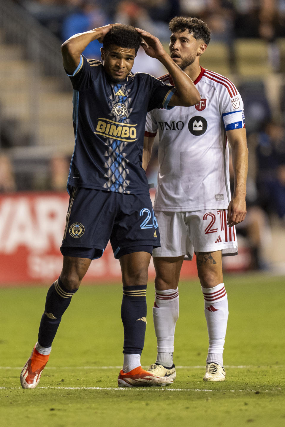 Philadelphia Union's Nathan Harriel, left, reacts to missing on a shot, next to Toronto FC's Jonathan Osorio during the second half of an MLS soccer match Wednesday, May 29, 2024, in Chester, Pa. (AP Photo/Chris Szagola)