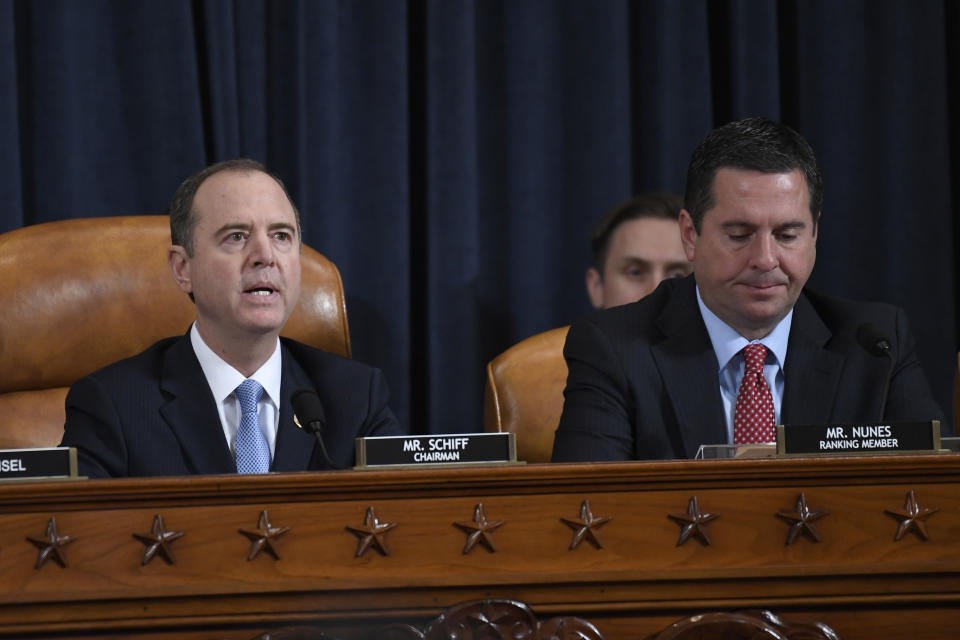 House Intelligence Committee Chairman Adam Schiff of Calif., left, speaks as Rep. Devin Nunes, R-Calif., the ranking member on the committee listens during the House Intelligence Committee on Capitol Hill in Washington, Wednesday, Nov. 13, 2019, in the first public impeachment hearing of President Donald Trump's efforts to tie U.S. aid for Ukraine to investigations of his political opponents. (AP Photo/Susan Walsh)