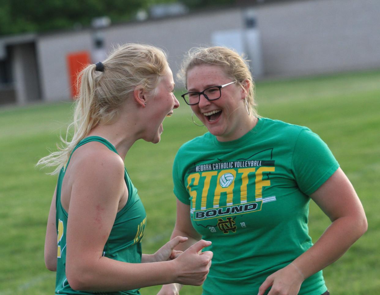 Newark Catholic's Erin Keck, left, celebrates winning the discus with her sister Mary-Brigid Keck during the first day of the Licking County League-Cardinal Division championship at Heath on Wednesday, May 8, 2024.