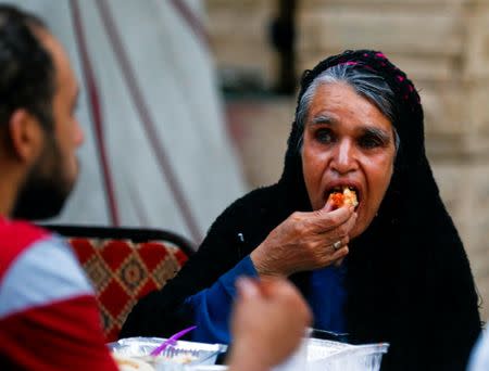 A Muslim woman eats food prepared by Coptic Christians during Ramadan in Cairo, Egypt June 18, 2017. Picture taken June 18, 2017. REUTERS/Mohamed Abd El Ghany