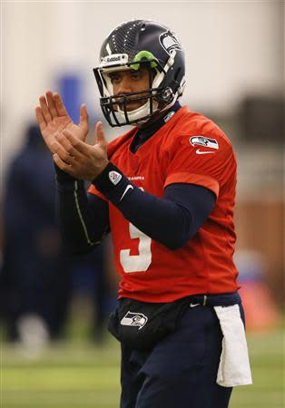 Seattle Seahawks quarterback Russell Wilson claps during their NFL Super Bowl XLVIII football practice in East Rutherford, New Jersey, January 30, 2014. REUTERS/Shannon Stapleton