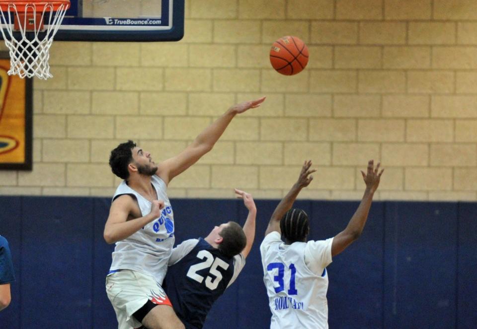 Quincy's Mohammad Tarjali, left, knocks away the shot of Cohasset's Jack Cullinan, right, during a boys basketball preseason scrimmage at Quincy High School, Thursday, Dec. 7, 2023.