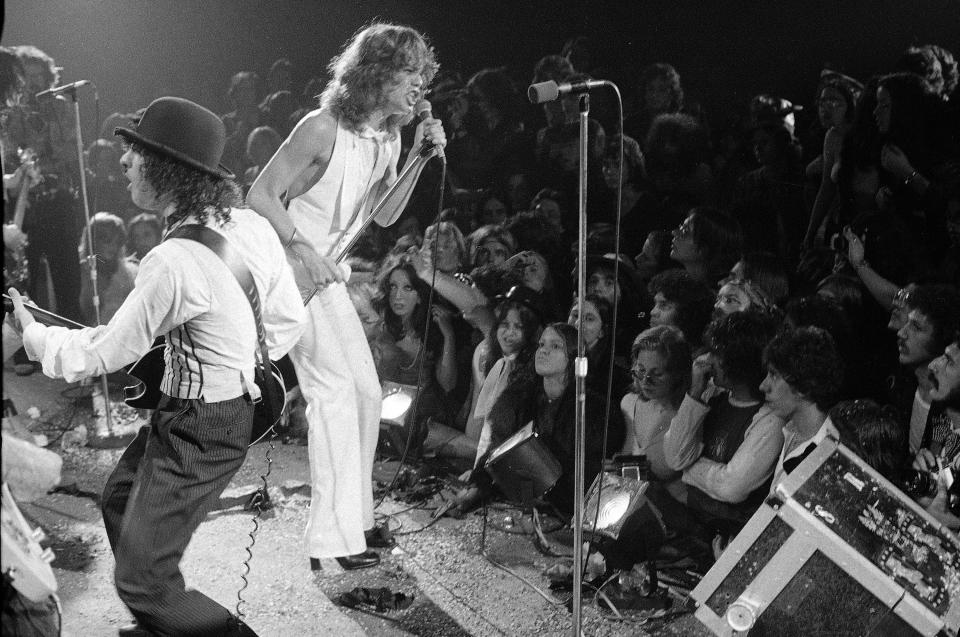 Rock group "The New York Dolls" perform at the Waldorf Halloween Ball, Waldorf-Astoria Hotel, NYC, Oct. 31, 1973. At right is lead singer David Johansen, with guitarist Sylvain Sylvain. (AP Photo/Richard Drew)