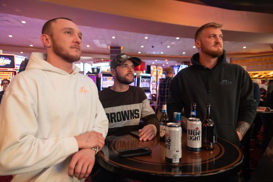 Browns fans Nigel Kelley, Brandon Williams and Sam Hulick watch the game after placing bets Sunday.