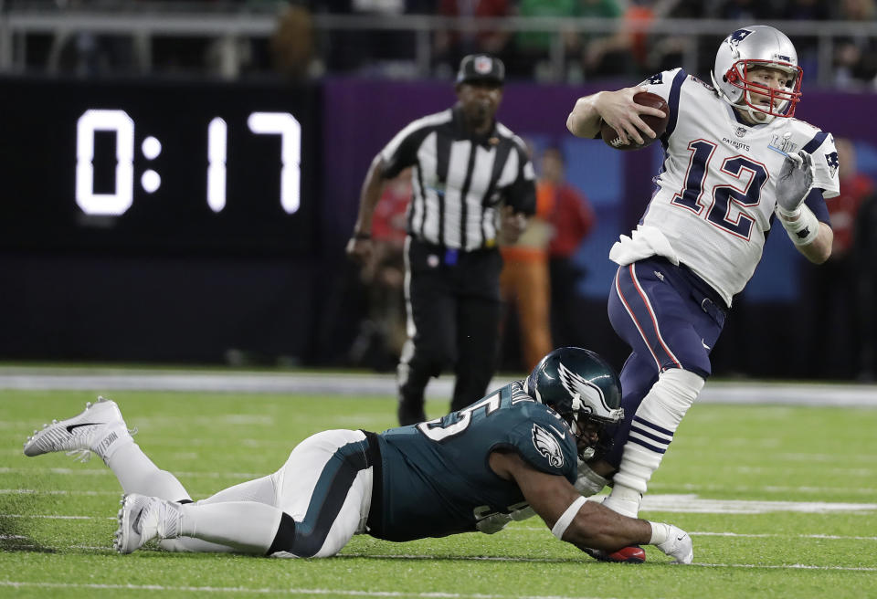 New England Patriots’ Tom Brady (12) runs from Philadelphia Eagles’ Brandon Graham during Super Bowl LII in Minneapolis. (AP/Mark Humphrey)