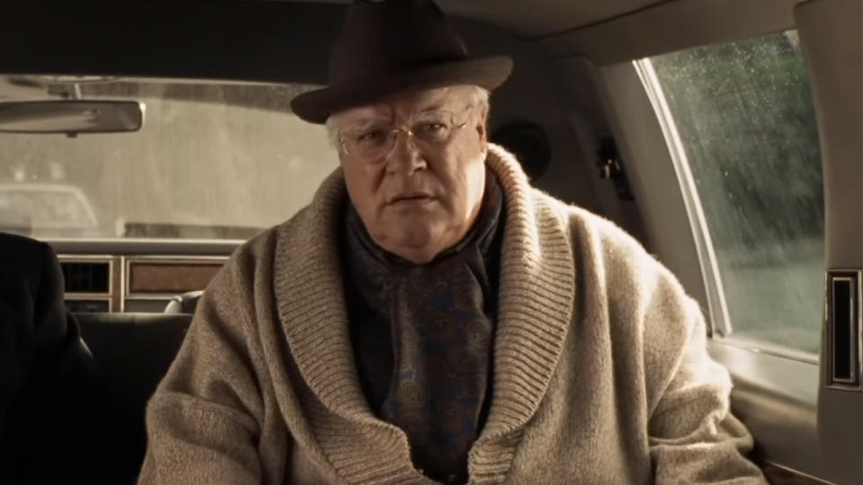 David Huddleston in a hat and a sweater in a limo in The Big Lebowski