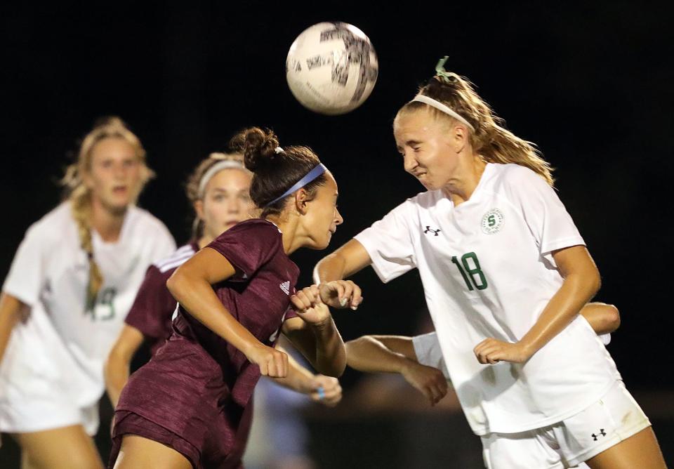 Walsh sophomore Hannah Pachan, left, attempts to head the ball against Strongsville's Kylie Jicha during the second half of a soccer game, Wednesday, Aug. 24, 2022, in Cuyahoga Falls, Ohio.