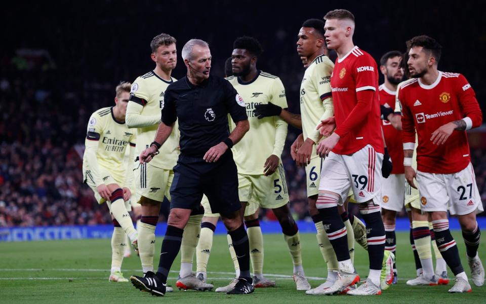 Players surround referee Martin Atkinson after Arsenal's Emile Smith Rowe scores their first goal - Reuters