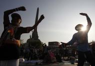 Anti-government protesters exercise as they take part in a rally at the Victory Monument in Bangkok January 21, 2014. Some Thai rice farmers have threatened to switch sides and join protesters trying to topple the government if they do not get paid for their crop, a worrying development for Prime Minister Yingluck Shinawatra whose support is based on the rural vote. REUTERS/Chaiwat Subprasom (THAILAND - Tags: POLITICS CIVIL UNREST)