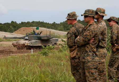 A Japan Ground Self Defense Force's Type 90 tank takes part in their joint exercise, named Northern Viper 17, as U.S. Marine Corps' members look on, at Hokudaien exercise area in Eniwa, on the northern island of Hokkaido, Japan, August 16, 2017. REUTERS/Toru Hanai