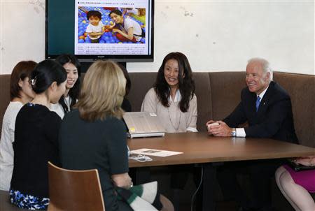 U.S. Vice President Joe Biden (R) and U.S. Ambassador to Japan Caroline Kennedy (4th L) meet employees of internet commerce and mobile games provider DeNA Co as they inspect the company headquarters in Tokyo December 3, 2013. REUTERS/Toru Hanai