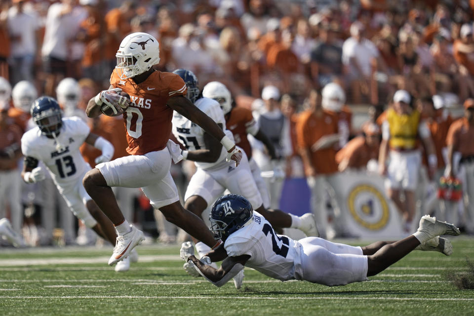 Texas tight end Ja'Tavion Sanders (0) runs for a touchdown past Rice cornerback Jonathan Jean (22) after making a catch during the second half of an NCAA college football game in Austin, Texas, Saturday, Sept. 2, 2023. (AP Photo/Eric Gay)