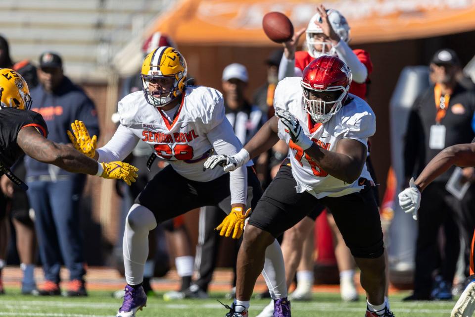Charles Turner III of LSU (69) and Patrick Paul of Houston (76) look to block during practice for the Senior Bowl, Jan. 31, 2024, in Mobile, Alabama.