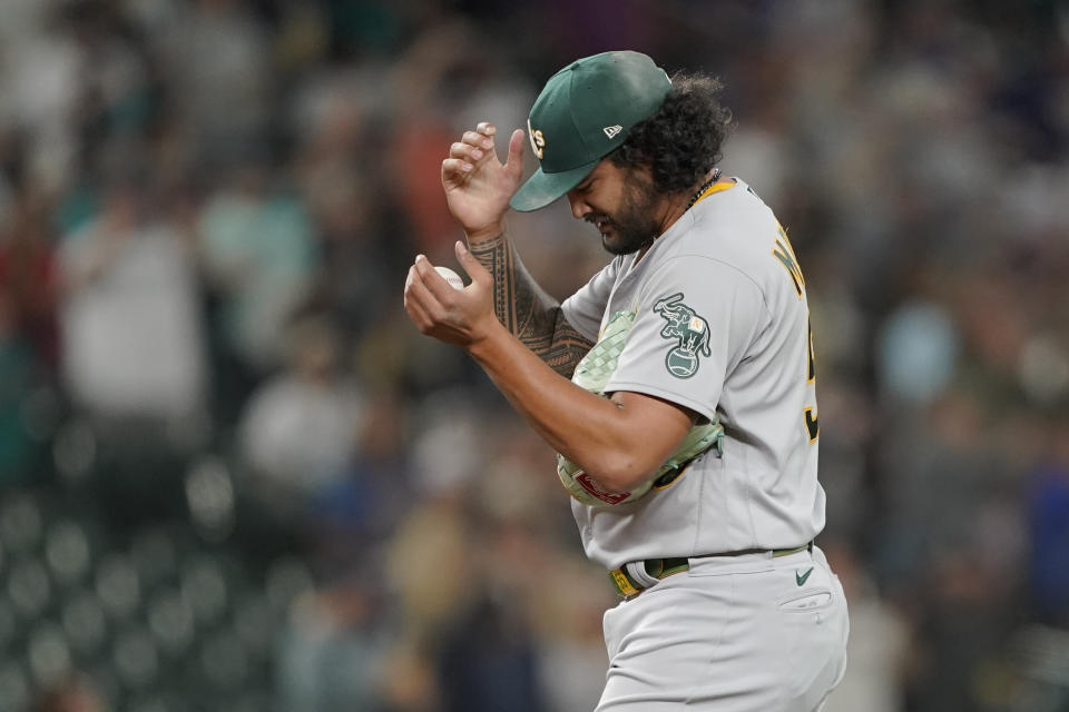 Oakland Athletics starting pitcher Sean Manaea pauses after he gave up a solo home run to Seattle Mariners' Tom Murphy during the seventh inning of a baseball game Thursday, July 22, 2021, in Seattle. (AP Photo/Ted S. Warren)