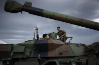 FILE - French troops inspect military vehicles at the Mihail Kogalniceanu Air Base, near the city of Constanta, Romania, Tuesday, June 14, 2022. Seven decades after it was founded, the North Atlantic Treaty Organization is meeting in Madrid on June 29 and 30, 2022 with an urgent need to reassert its original mission: preventing Russian aggression against Western allies. (Yoan Valat, Pool via AP, File)